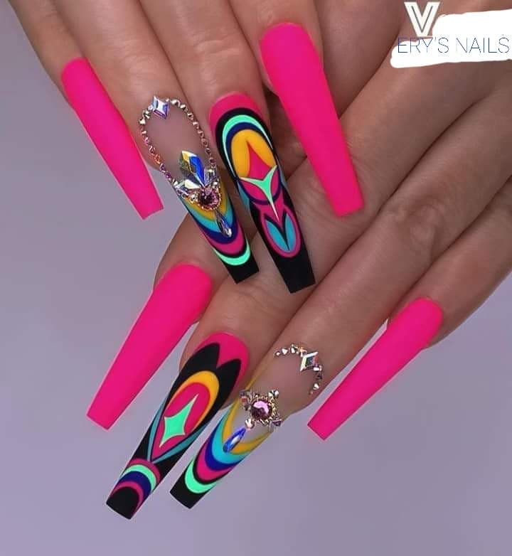 A woman with long nails and bright pink nail polish.