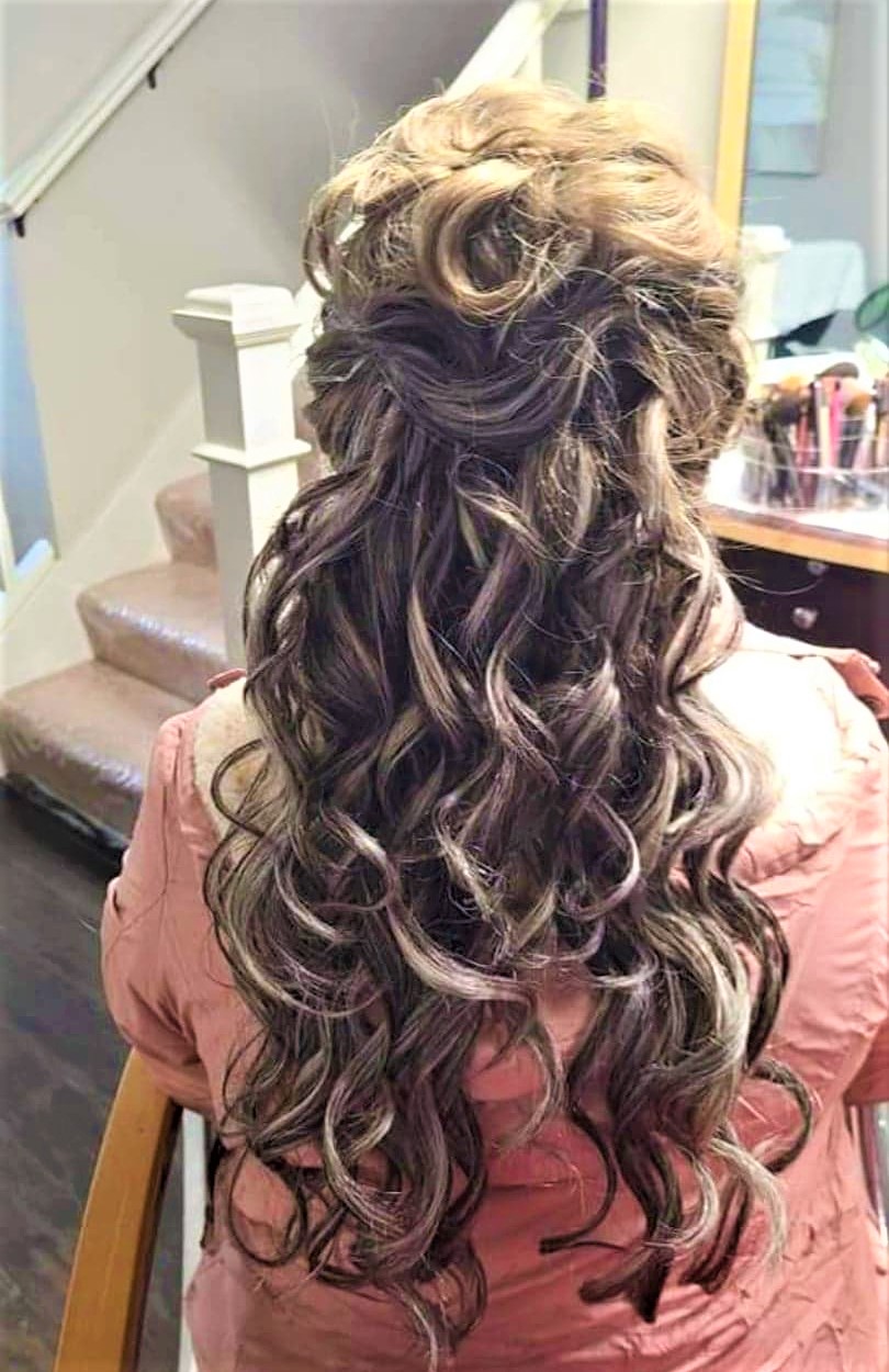 A woman with long hair is sitting down